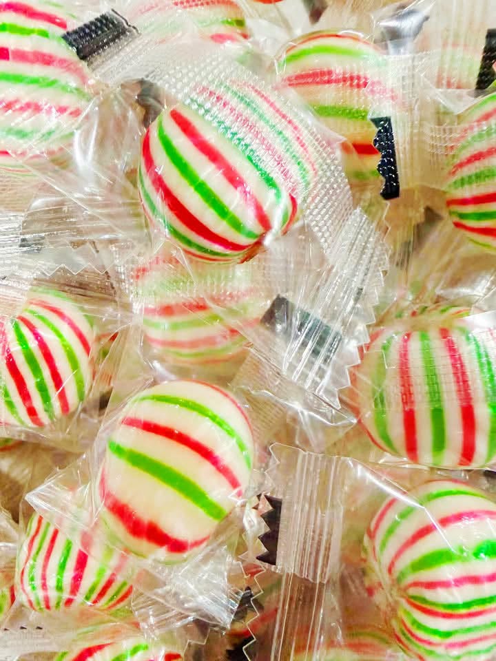 Close-up of striped mint sweets in wrappers